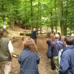 Leo who manages the woodland at Chinthurst Hill explains to his colleagues the current coppicing operations and future plans for the woodland.