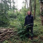 Ranger Marie-Anne Phillips standing next to a recently coppiced hazel in Tinkers Copse