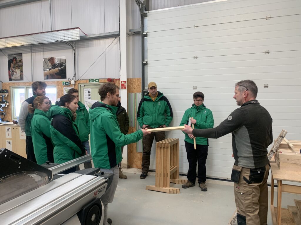 Senior Tutor Phil Gullam explaining the Wood School's use of homegrown timber to NFPN members .